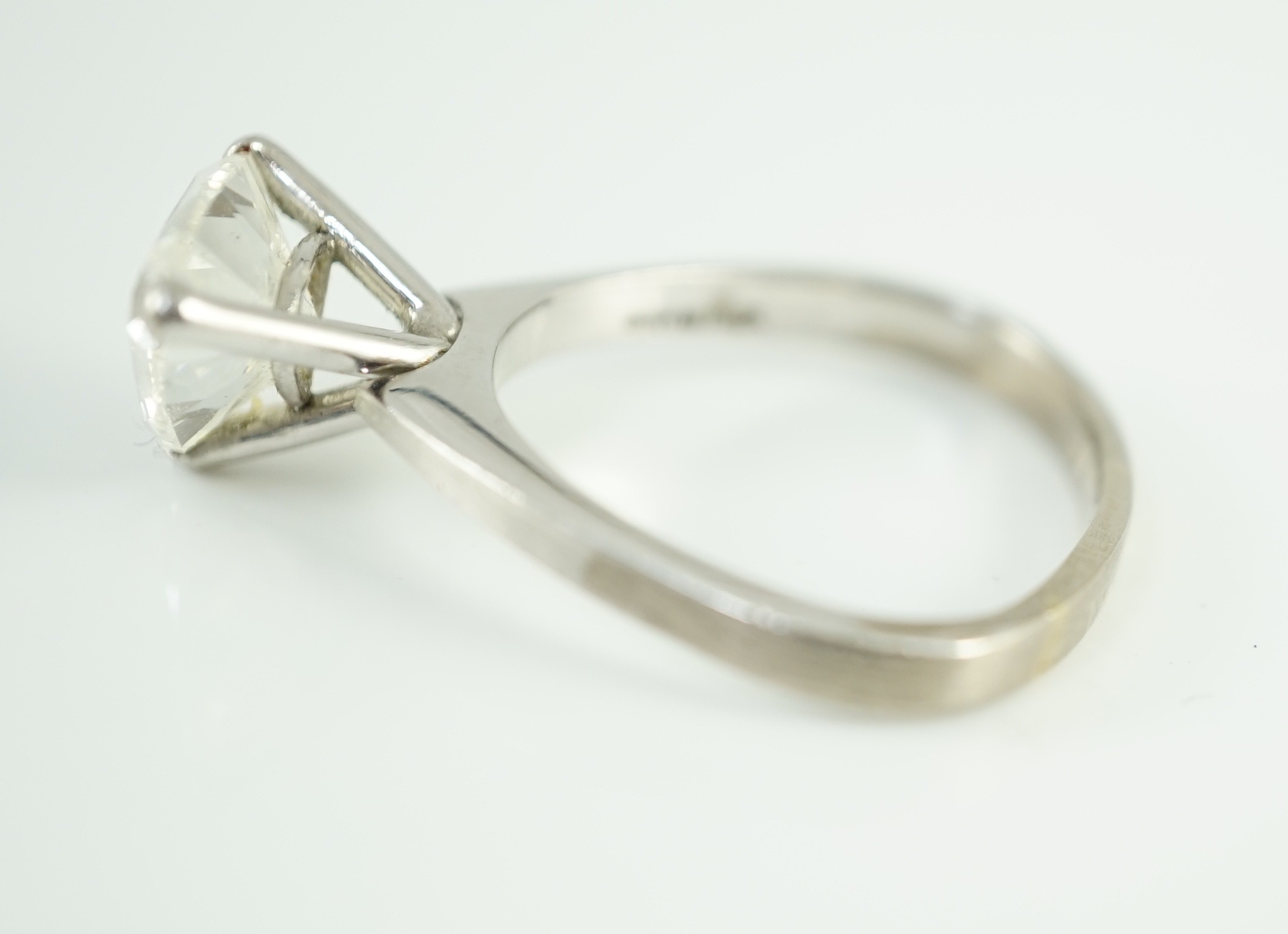 A modern platinum and solitaire trillion cut diamond set ring